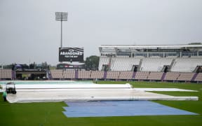 The scoreboard shows that play has been abandoned for the day as the covers fill the field
New Zealand BlackCaps v India.
Day 1 of the ICC World Test Championship Final at Southampton,