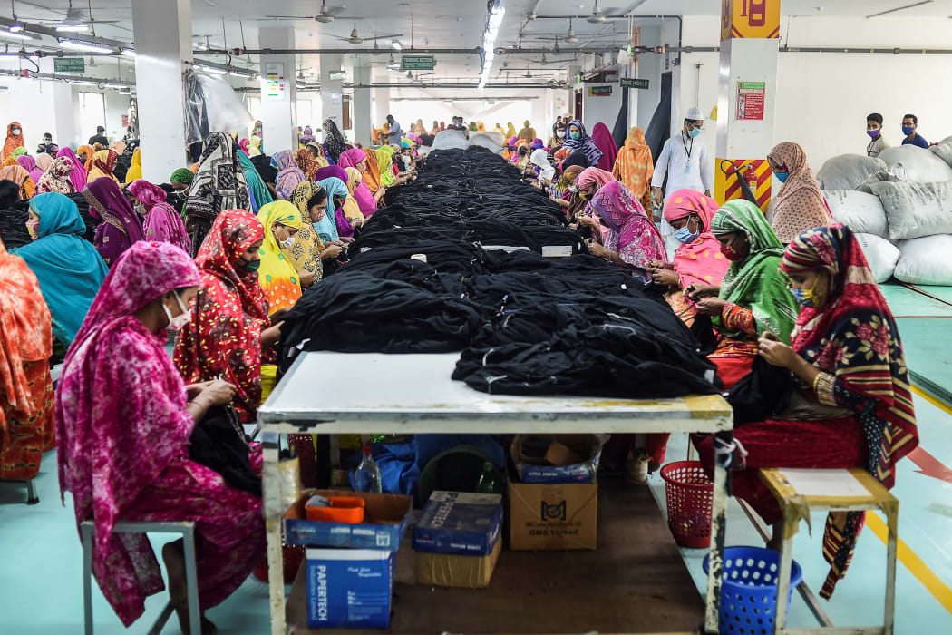 In this picture taken on March 15, 2021, women work in a garment factory in Gazipur in Bangladesh.