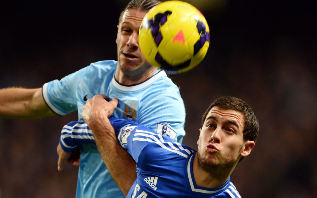 Eden Hazard of Chelsea tangles with Martin Demichelis.