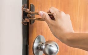 Female hand on handle, opening or closing door
