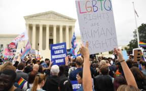 Demonstrators in favour of LGBT rights rally outside the US Supreme Court in Washington, DC, October 8, 2019, as the Court holds oral arguments in three cases dealing with workplace discrimination based on sexual orientation. (Photo by SAUL LOEB / AFP)