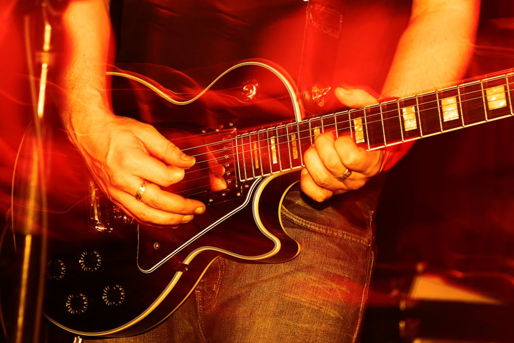 14291219 - closeup of an guitarist at a rock concert, motioneffect!