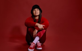 Young Māori woman sitting cross legged