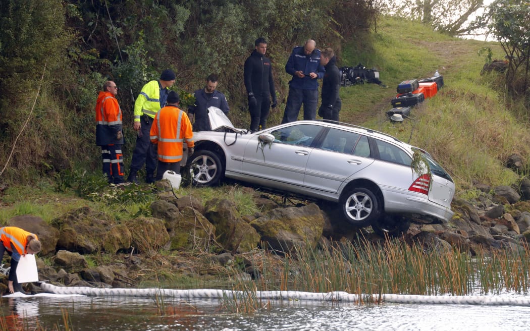 A car is winched out of Lake Rotoma after a crash that claimed two lives.