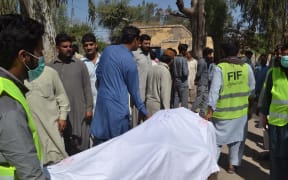 Pakistani emergency workers transport the body of a victim to hand over to their relatives at a hospital in the garrison city of Sargodha, in Punjab province, Pakistan on April 2, 2017.