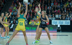 Natalie Medhurst from Australia tries to pass to team mate Caitlin Bassett from Australia as Casey Kopua from New Zealand pressures her during the New Zealand Silver Ferns vs Australian Diamonds netball test match, the second game of the 2015 Constellation Cup.
