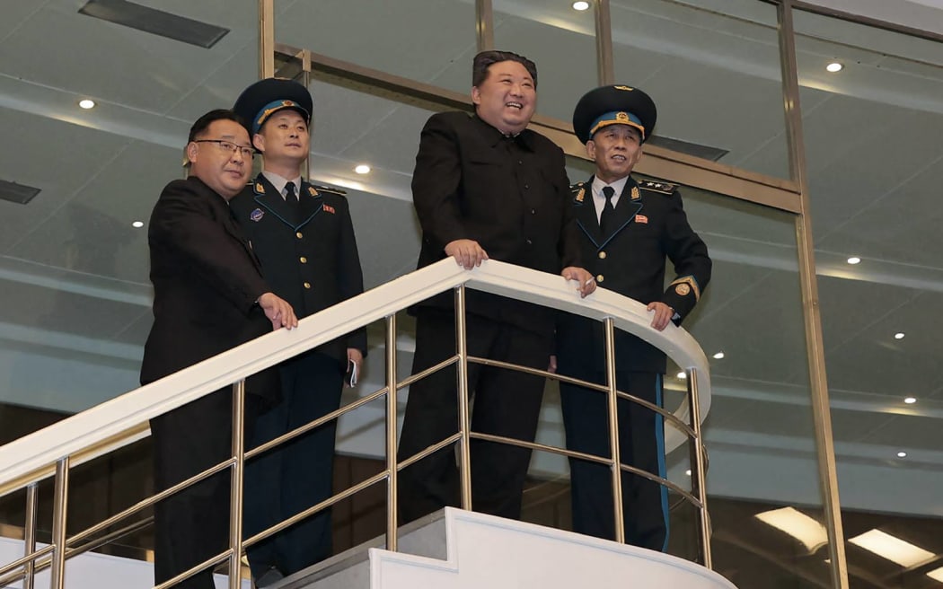 This picture taken and released on November 22, 2023 from North Korea's official Korean Central News Agency (KCNA) shows North Korea's leader Kim Jong Un (2nd R) visiting the Pyongyang General Control Centre of the Korean National Aerospace Technology Directorate, a day after the launch of a rocket carrying the reconnaissance satellite 'Malligyong-1', in Pyongyang. North Korea said on November 22 it had succeeded in putting a military spy satellite in orbit after two previous failures, as the US led its allies in condemning the launch as a "brazen violation" of UN sanctions. (Photo by KCNA VIA KNS / AFP) / South Korea OUT / REPUBLIC OF KOREA OUT
---EDITORS NOTE--- RESTRICTED TO EDITORIAL USE - MANDATORY CREDIT "AFP PHOTO/KCNA VIA KNS" - NO MARKETING NO ADVERTISING CAMPAIGNS - DISTRIBUTED AS A SERVICE TO CLIENTS / THIS PICTURE WAS MADE AVAILABLE BY A THIRD PARTY. AFP CAN NOT INDEPENDENTLY VERIFY THE AUTHENTICITY, LOCATION, DATE AND CONTENT OF THIS IMAGE --- /