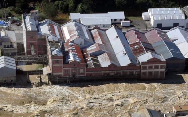 The flooded Mataura River rips past the former Mataura paper mill