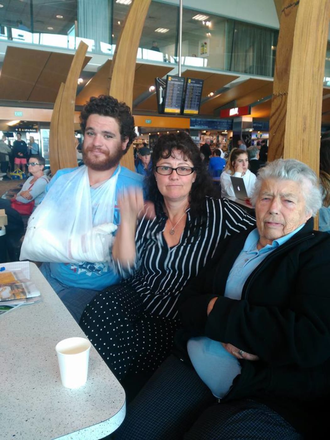 Stranded passenger Vickie Davis, centre, with fellow Air New Zealand passengers initially offered only a pillow and blanket. 
Named on social media as Augustus Whanga, left, and Gillian Finnegan, 84, right.