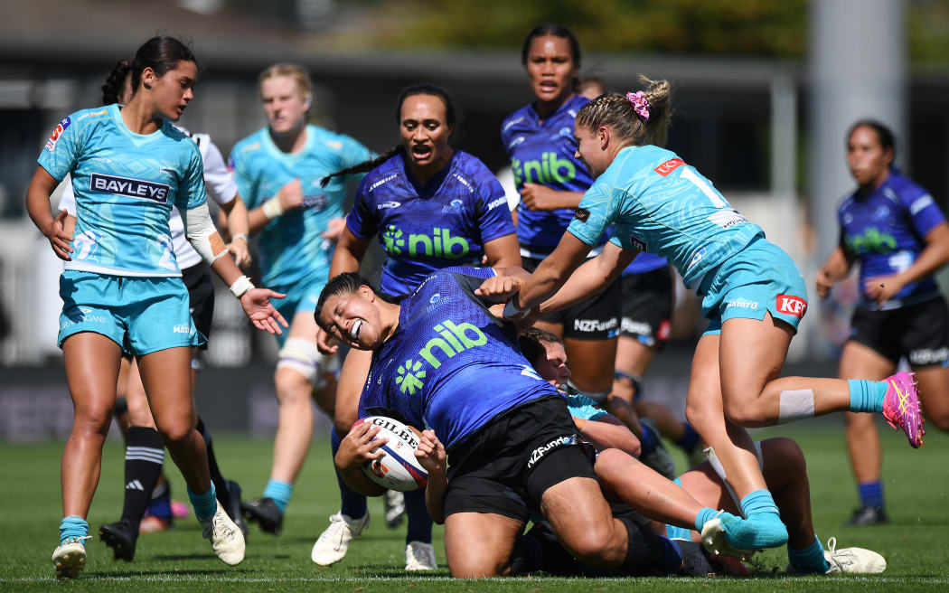 Blues player Dajian Brown is tackled during the Super Rugby Aupiki match against Matatū.