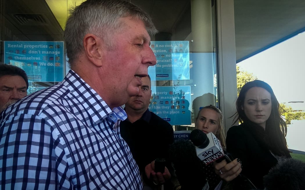 Maurice Williamson talks to reporters outside his electorate office in Auckland.