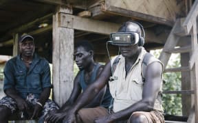 Former combatant and now cocoa farmer Timothy Koluvai experiences a VR film for the first time.