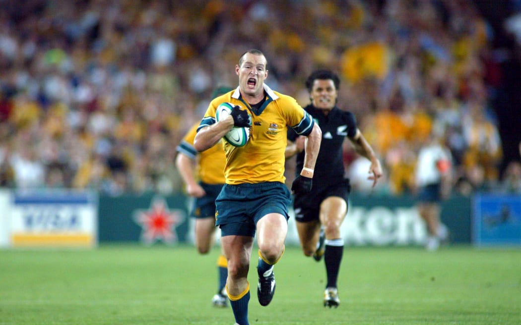 Stirling Mortlock charges away from All Black defence during the 2003 World Cup semi final in Sydney.
