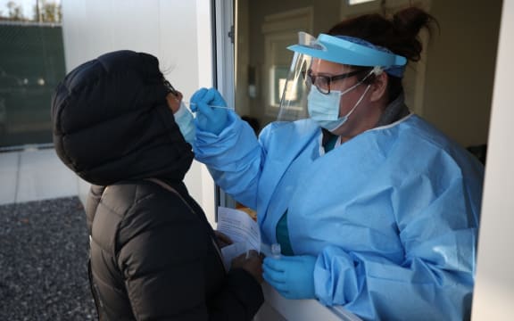 NEW YORK, USA - NOVEMBER 18: A woman is getting her coronavirus test as people line up for free COVID-19 test ahead of Thanksgiving in Queens of New York City, United States on November 18, 2020.