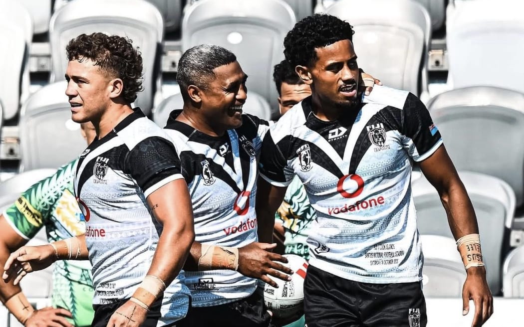 Fiji Bati players Kurt Donoghoe (left) and Michael Jennings (centre) celebrate Jahream Bula's try against Cook Islands, in Port Moresby, on Saturday 18 October, 2025.