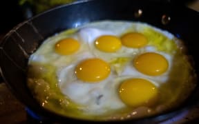 A pan filled with fried eggs.