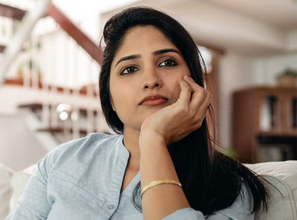 Woman of Indian appearance looking thoughtful