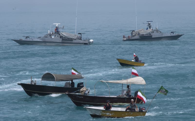 Two Islamic Revolutionary Guard Corps (IRGC) Navy warships and Basij paramilitary force speed boats are sailing along the Persian Gulf during the IRGC marine parade, which is commemorating the Persian Gulf National Day, near the Bushehr nuclear power plant in the seaport city of Bushehr, Bushehr province, in the south of Iran, on April 29, 2024. The Persian Gulf National Day, celebrated on the 10th of Ordibehesht in the Iranian calendar, usually falls in late April or early May and commemorates the expulsion of the Portuguese from the Strait of Hormuz and the Persian Gulf in 1622 by the Safavid forces led by Imam Quli Khan under the command of Shah Abbas I. (Photo by Morteza Nikoubazl/NurPhoto) (Photo by Morteza Nikoubazl / NurPhoto via AFP)