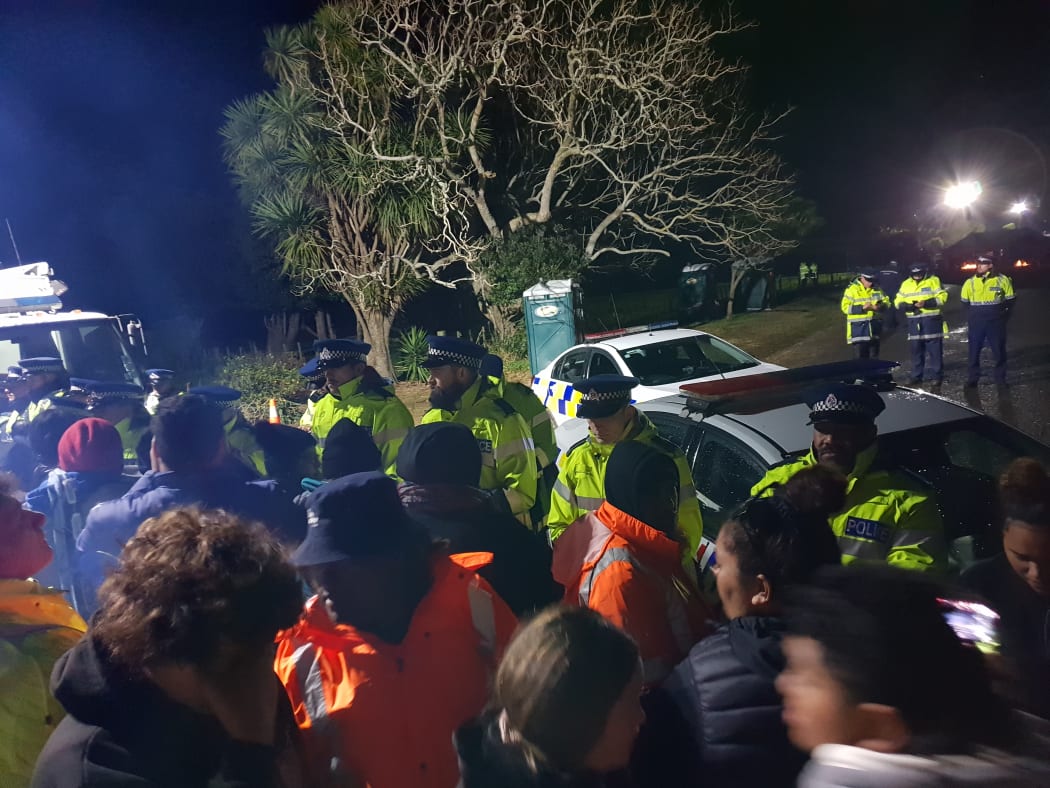 The police line at Ihumatao on Monday evening after more officers were brought in.
