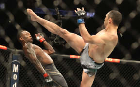 Israel Adesanya avoids a kick from Robert Whittaker, Houston 2022 at UFC 271.