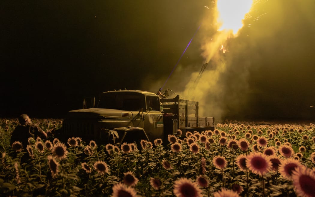 Ukrainian servicemen of the 59th brigade mobile air defence unit fire a Soviet made ZU-23 anti-aircraft twin autocannon towards a Russian drone from a sunflower field, during an air attack near Pavlograd, Dnipropetrovsk region on July 19, 2025, amid the Russian invasion of Ukraine.