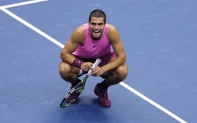Carlos Alcaraz reacts after winning match point to defeat Jannik Sinner in their US Open men's singles final.