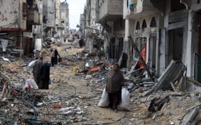 Palestinians carry some of their belongings as they flee Khan Yunis in the southern Gaza Strip on March 7, 2024, amid ongoing battles between Israel and the Palestinian militant group Hamas. (Photo by AFP)