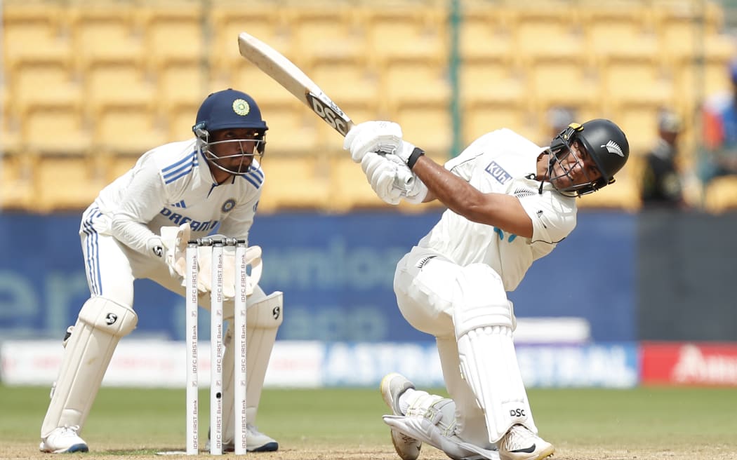 Rachin Ravindra of New Zealand hits over the top for six during the first test against India.
