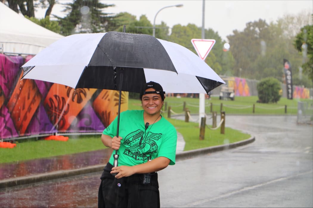 Getting the job done - a Polyfest volunteer who was still smiling as the wind blew and rain poured.