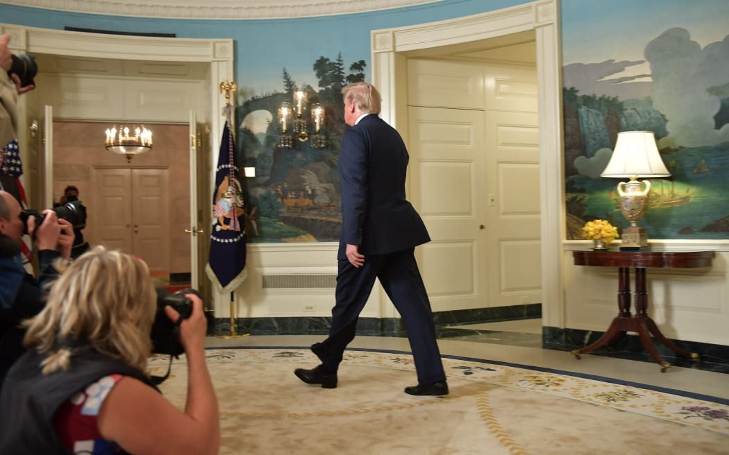 US President Donald Trump departs after addressing the nation on the situation in Syria.