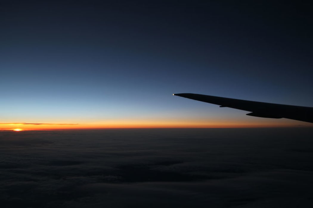 Plane wing at night with sunset (stock)