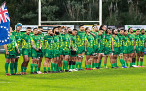 The Cook Islands rugby team stand for the national anthem.