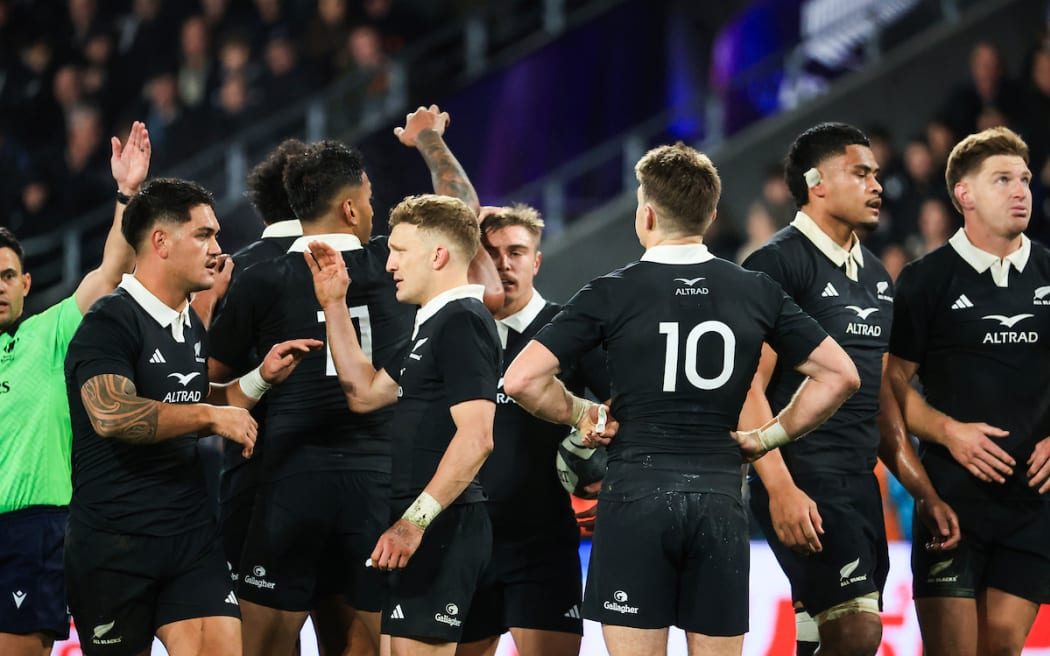 The All Blacks celebrate after beating France.