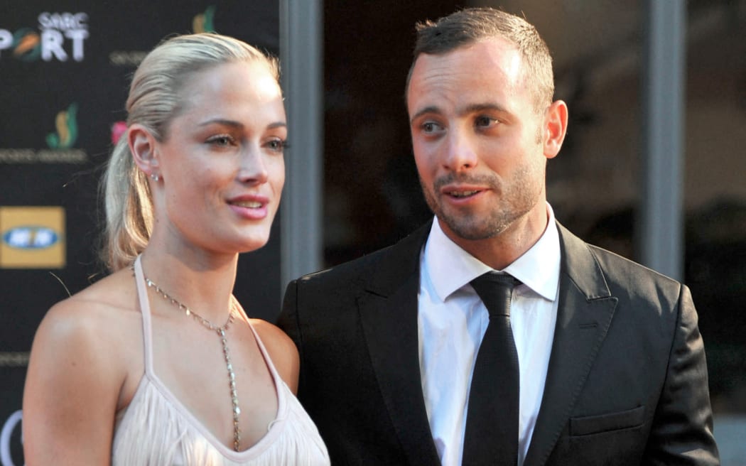 (FILES) This picture taken on November 4, 2012 during the Feather Awards held at Melrose Arch in Johannesburg shows South Africa's Olympic sprint star Oscar Pistorius and his model girlfriend Reeva Steenkamp. The mother of Reeva Steenkamp, a South African model killed by ex-Olympian Oscar Pistorius, is the one "serving a life sentence", she said in a statement on January 5, 2024 ahead of his release from prison. (Photo by LUCKY NXUMALO / AFP)