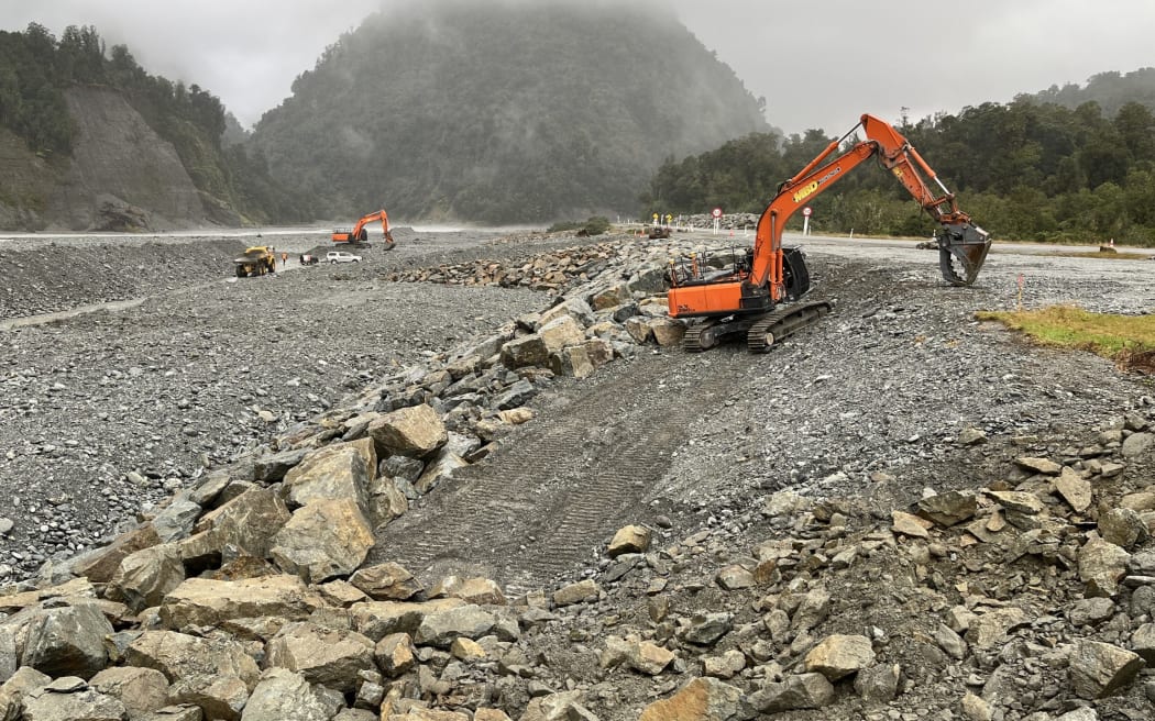 Contractors for the West Coast Regional Council and the NZ Transport Agency work on new rock 'riprap' on the south side of the State highway 6 Waiho River Bridge, an initial part of the stage one $12m authorised work.
