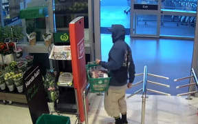 The man walked right into the path of an off-duty policeman as he exited the Henderson supermarket carrying the basket.