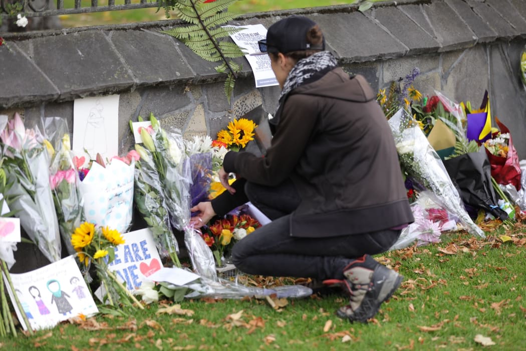 Flowers are laid at the special wall set up beside the Christchurch Botanical gardens.