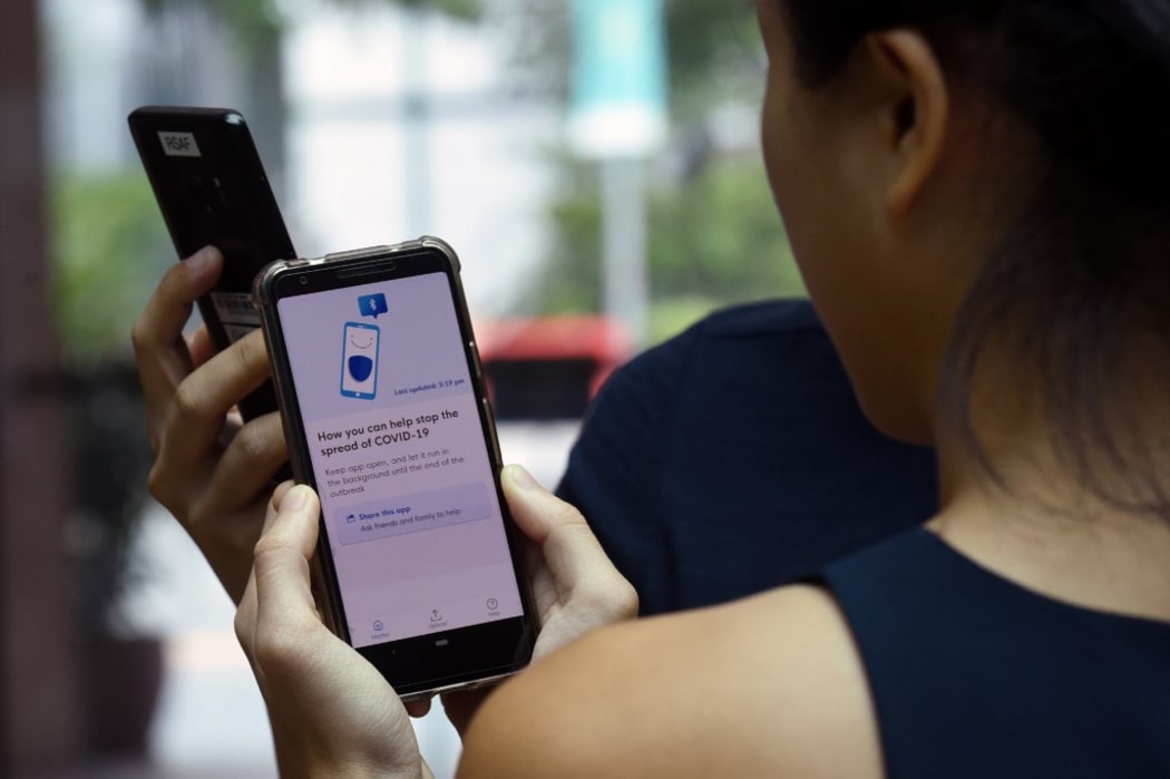 Government Technology Agency (GovTech) staff demonstrate Singapore's new contact-tracing smarthphone app called TraceTogether, as a preventive measure against the COVID-19 coronavirus in Singapore .