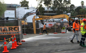 Workers at the sinkhole in Parnell, Auckland, that opened up after a main sewer line collapsed.