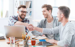 three men in an office
