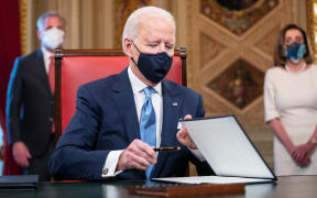 US President Joe Biden signs three documents including an Inauguration declaration, cabinet nominations and sub-cabinet noinations in the Presidents Room at the US Capitol after being sworn-in as the 46th president of the United States on January 20, 2021.