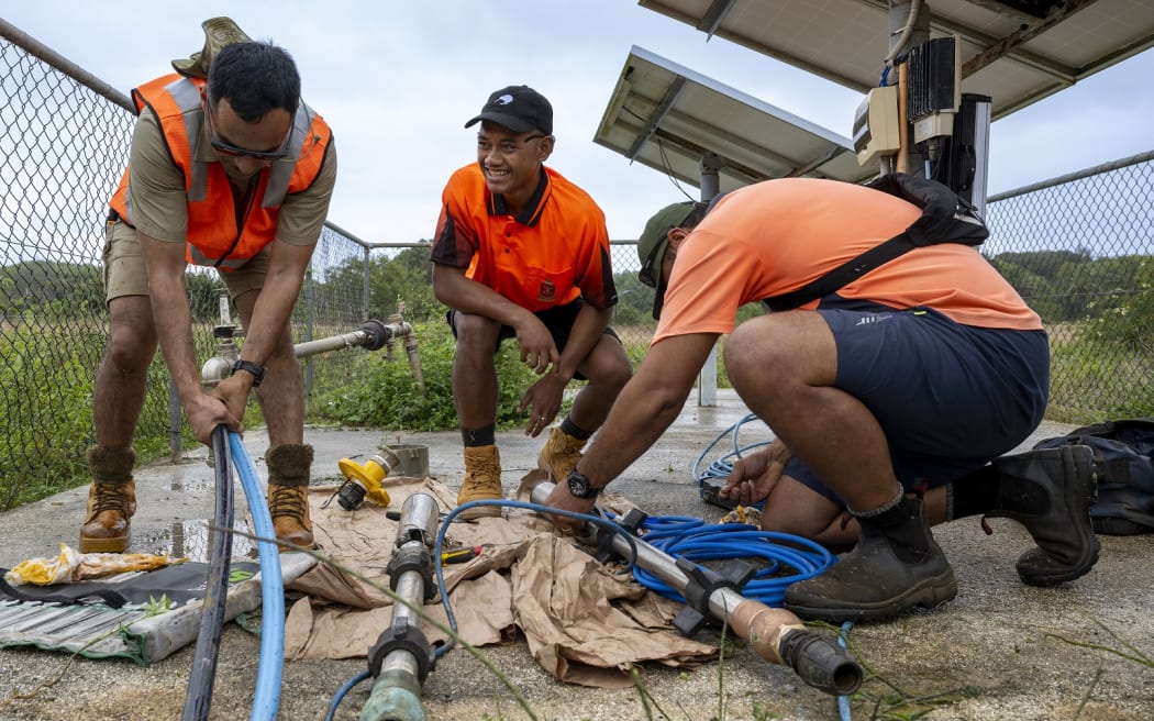 Australian Sapper Subash Giri, left, and Tongan Private Paea Tukuafu work at Ma’uke’s water farm with a local worker during Exercise Tropic Twilight