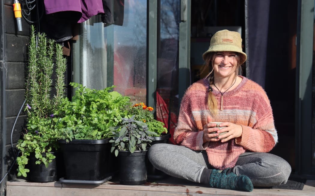 Kath Irvine on the porch of her house truck