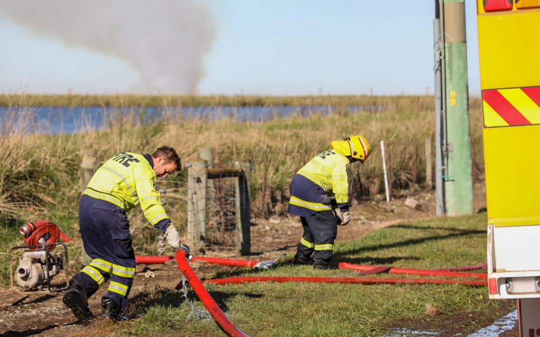 Fire crews south of Ashburton battled a large rural blaze burning through around 14,000 hay bales on Thursday.