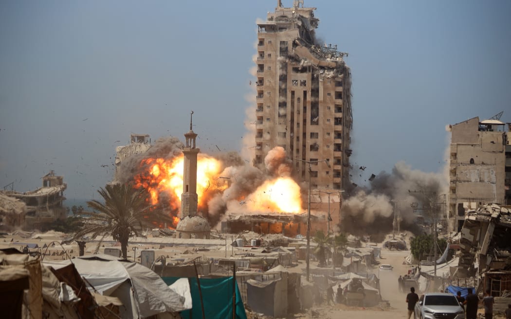 A ball of fire erupts from Mushtaha Tower as it is destroyed in an Israeli airstrike in Gaza City, on September 5, 2025. (Photo by Majdi Fathi/NurPhoto) (Photo by MAJDI FATHI / NurPhoto via AFP)