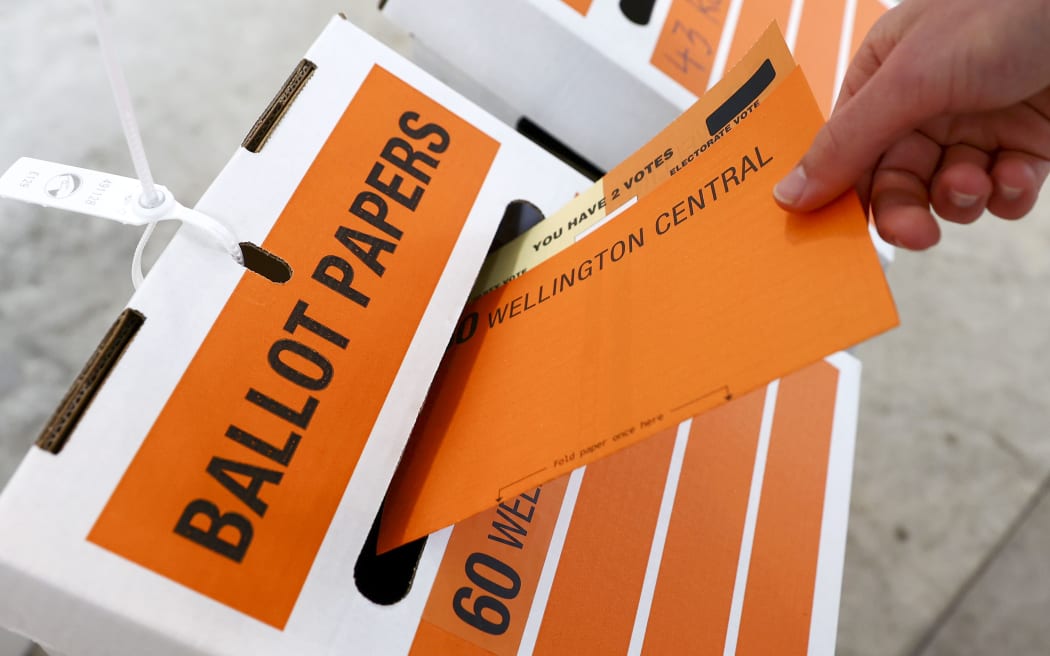 WELLINGTON, NEW ZEALAND - OCTOBER 17: A person casts their vote at a polling station during election day on October 17, 2020 in Wellington, New Zealand. Voters head to the polls today to elect the 53rd Parliament of New Zealand. The 2020 New Zealand General Election was originally due to be held on Saturday 19 September but was delayed due to the re-emergence of COVID-19 in the community. (Photo by Hagen Hopkins/Getty Images)