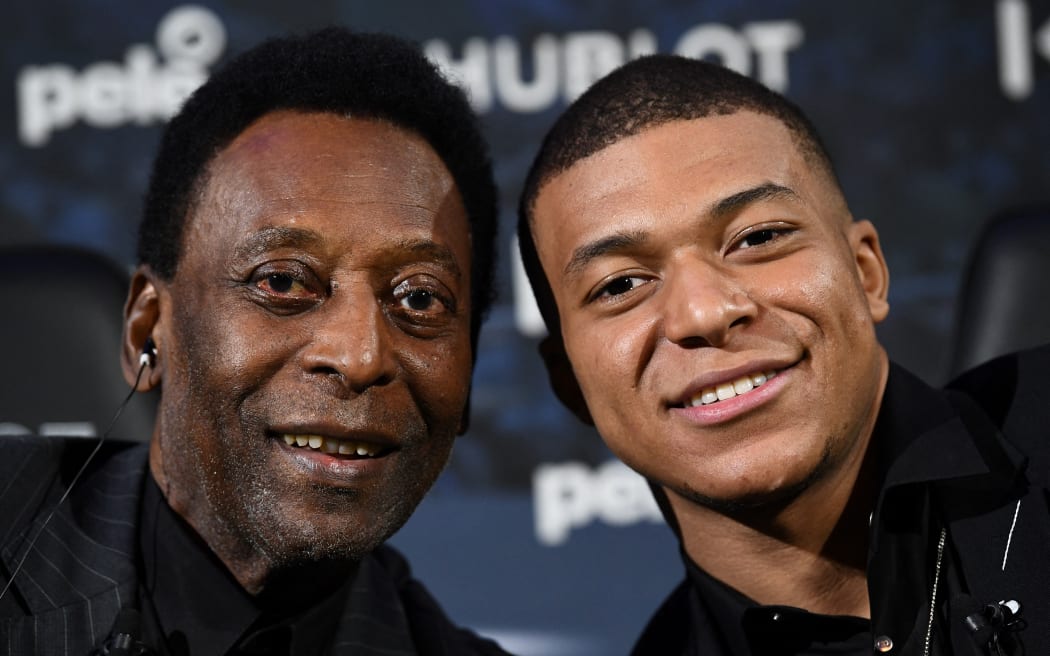 Paris Saint-Germain (PSG) and France national football team forward Kylian Mbappe  and Brazilian football legend Pele pose as they take part in a meeting at the Hotel Lutetia in Paris on April 2, 2019.