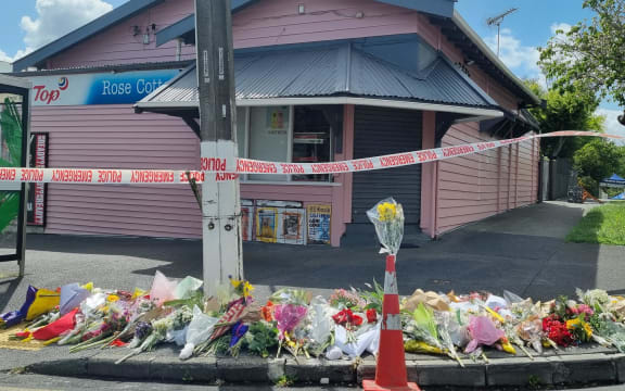 Flowers are seen outside Rose Cottage Superette in Sandringham, Auckland, after the fatal stabbing of a dairy worker on Wednesday, 23 November, 2022.