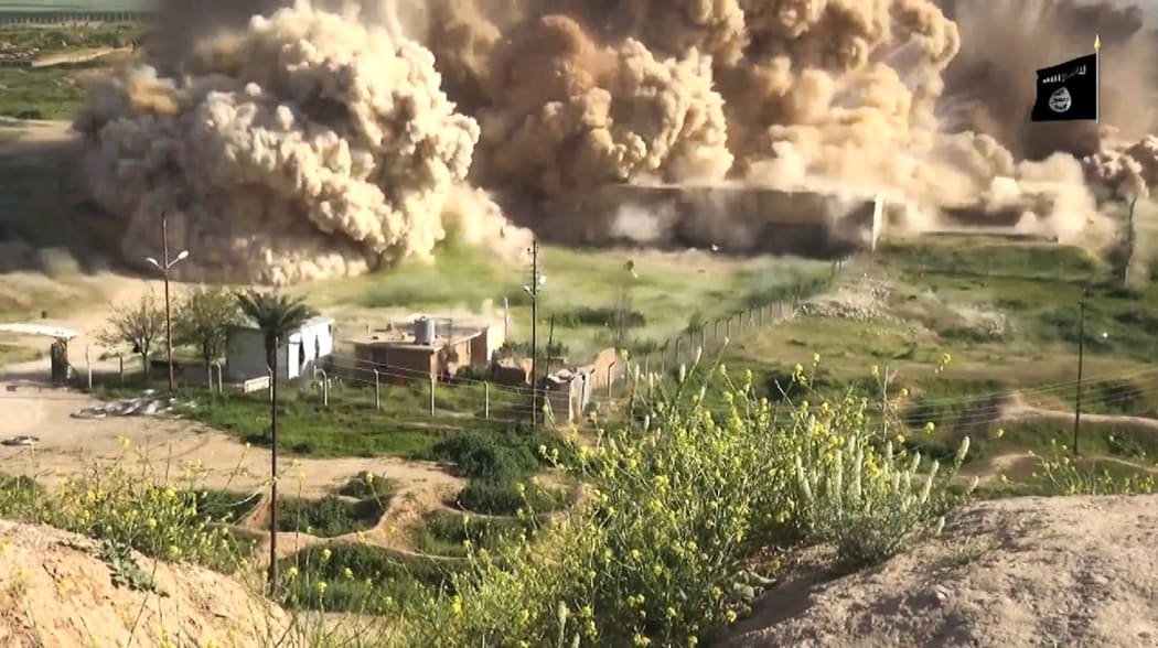 An image grab taken from a video made available by the Jihadist media outlet Welayat Nineveh showing explosives being detonated at the site.