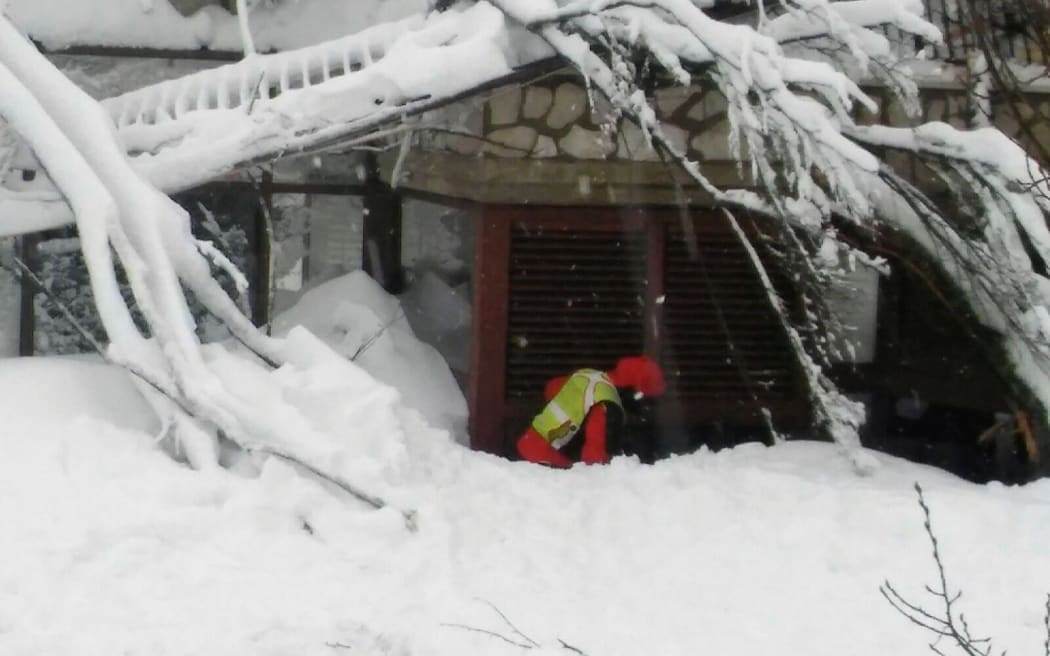 A rescuer at the Hotel Rigopiano.